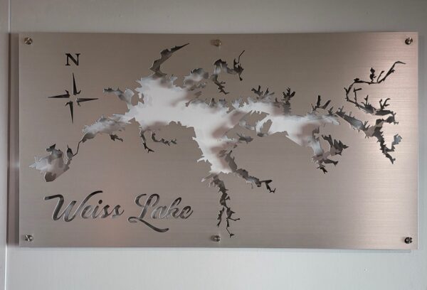 Weiss Lake metal map with compass rose, featuring intricate cutout design on brushed silver, mounted on a light wall.