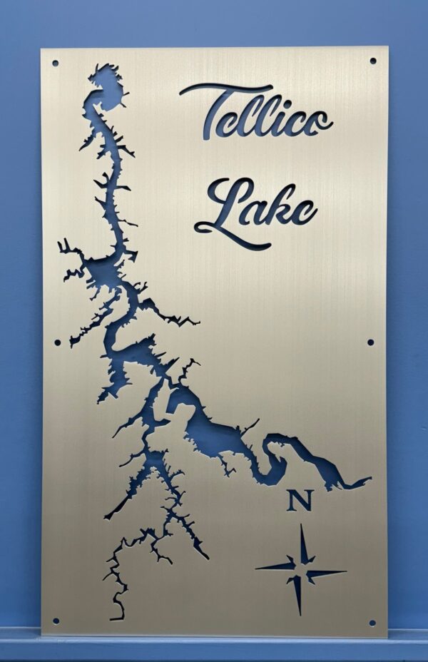 Tellico Lake metal map with compass rose, featuring cutout design on brushed silver, mounted on a blue wall.