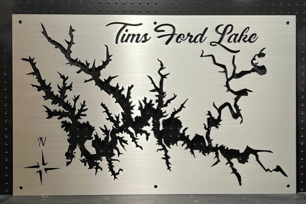 Tims Ford Lake metal map with intricate cutout design and compass rose on brushed silver, mounted on a pegboard.