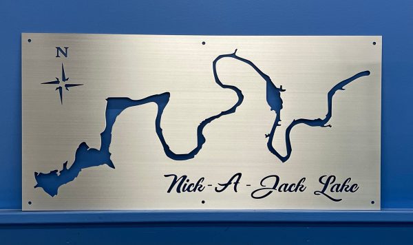 Nick-A-Jack Lake metal map with compass rose, mounted on a blue wall.