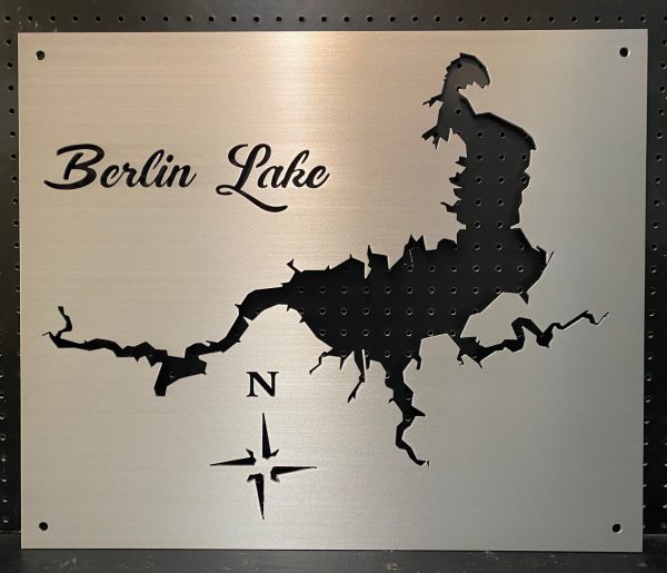 Berlin Lake metal map with cutout design and compass rose on a brushed background.