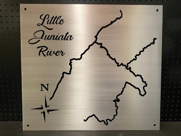 Little Juniata River metal map with compass rose, displayed on a black pegboard.