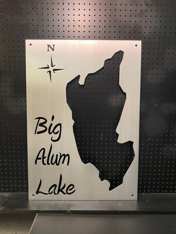 Big Alum Lake metal map with compass rose on a perforated black background.