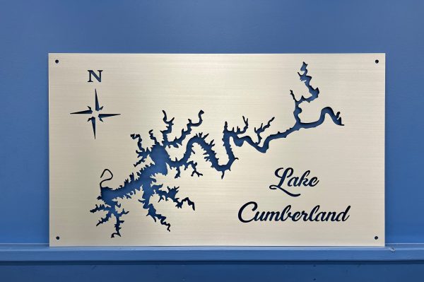 Lake Cumberland map on brushed metal with decorative script and compass rose, set against a blue wall.