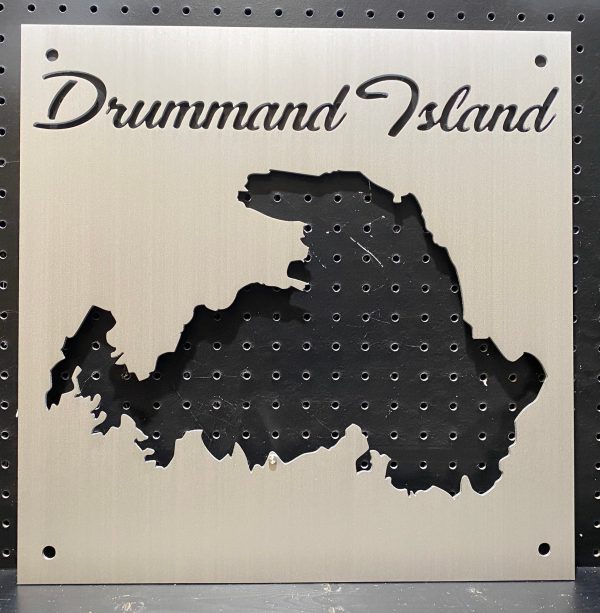 Custom Drummond Island metal map on a perforated black background.