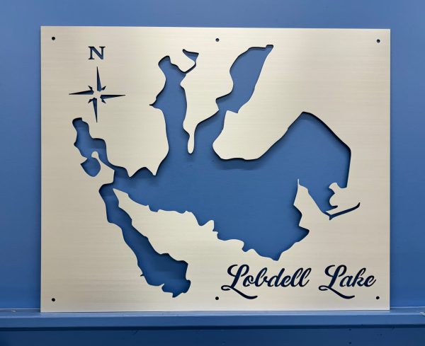 Lobdell Lake metal map with compass rose, mounted on a blue wall.