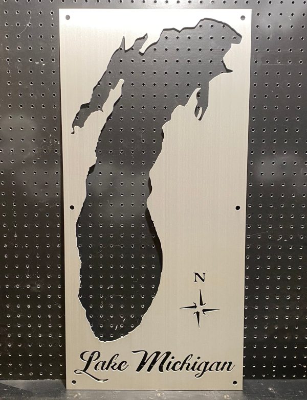 Lake Michigan cutout metal sign with compass rose on perforated black background.