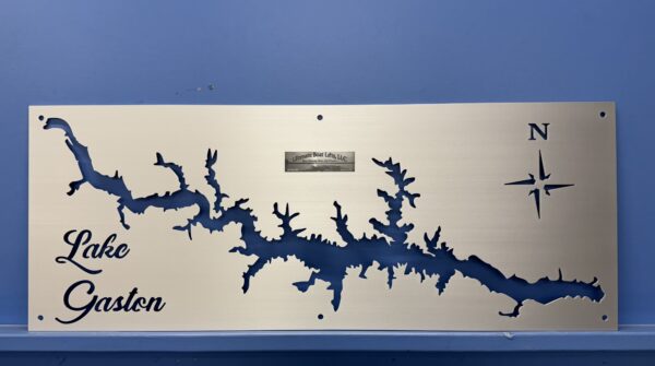Metal wall art of Lake Gaston map with compass rose and company logo, mounted on a blue wall.